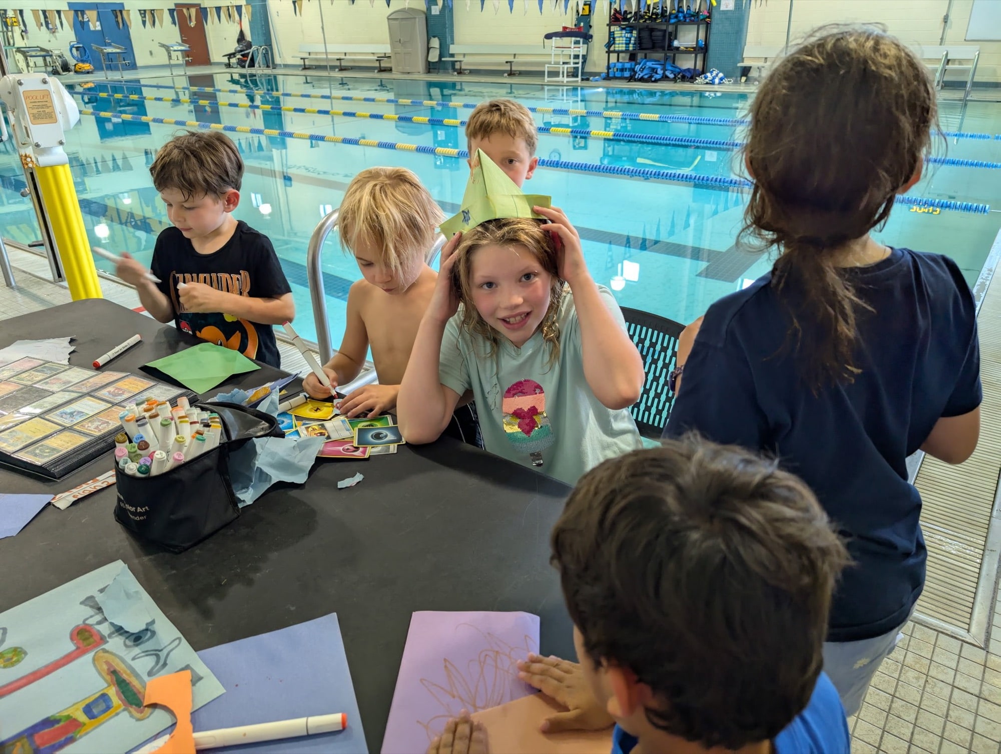 Kids doing crafts together at a party table